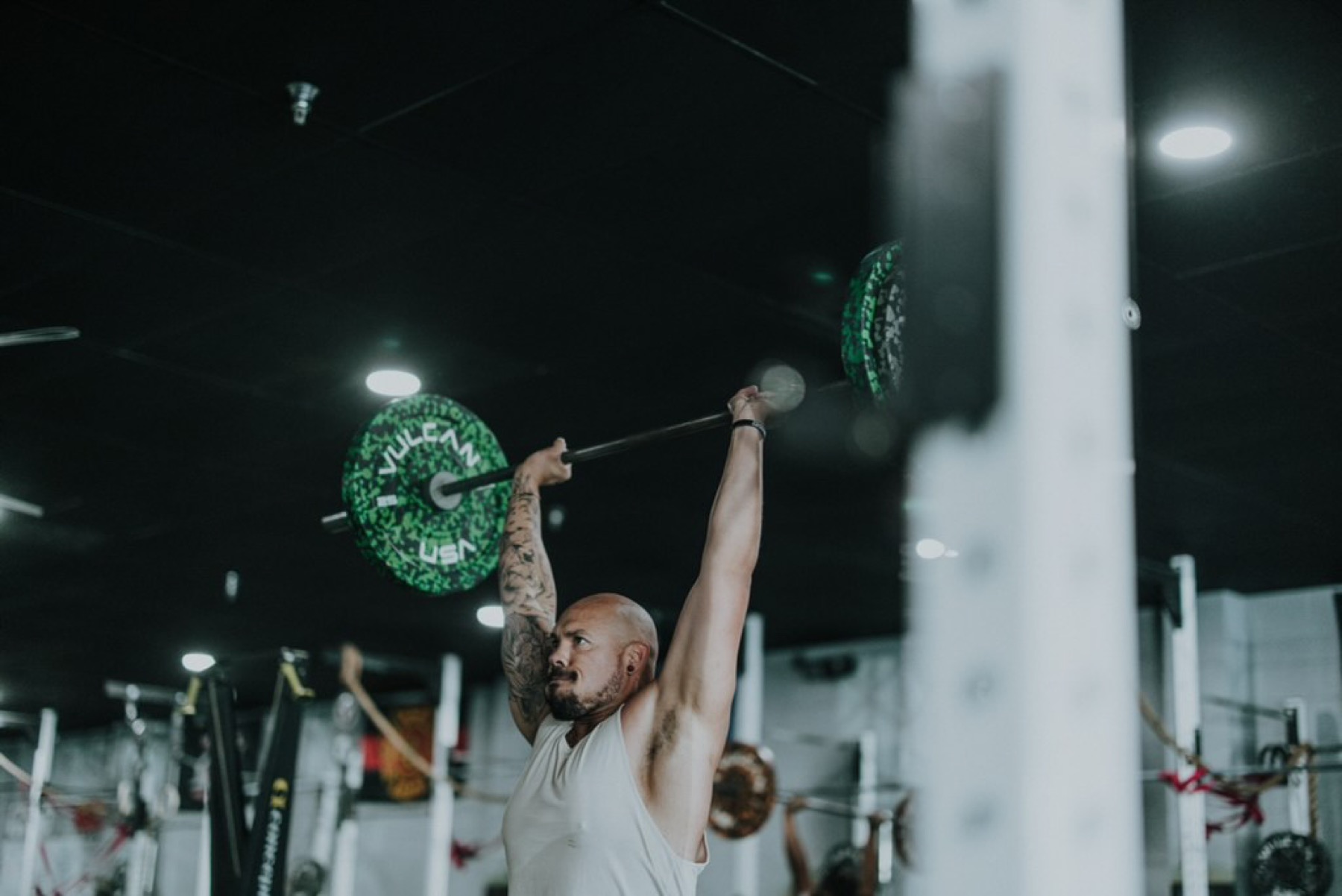 The TruFitness4Life coach completing an overhead barbell lift